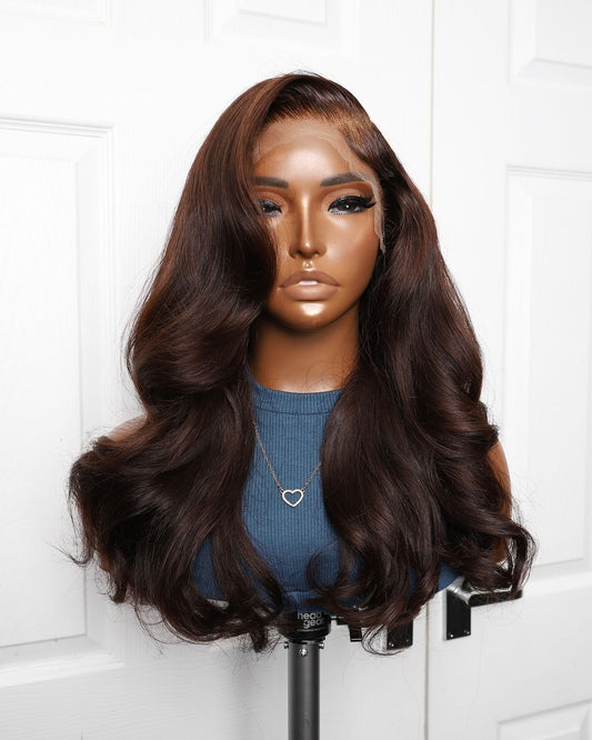 Chocolate brown body wave human hair wig with transparent lace and full volume.